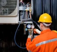 Technician checking an AC control panel